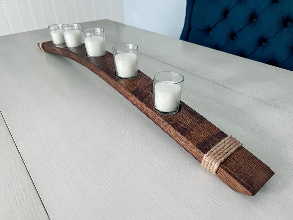 Side view of wine barrel candle holder on white table
