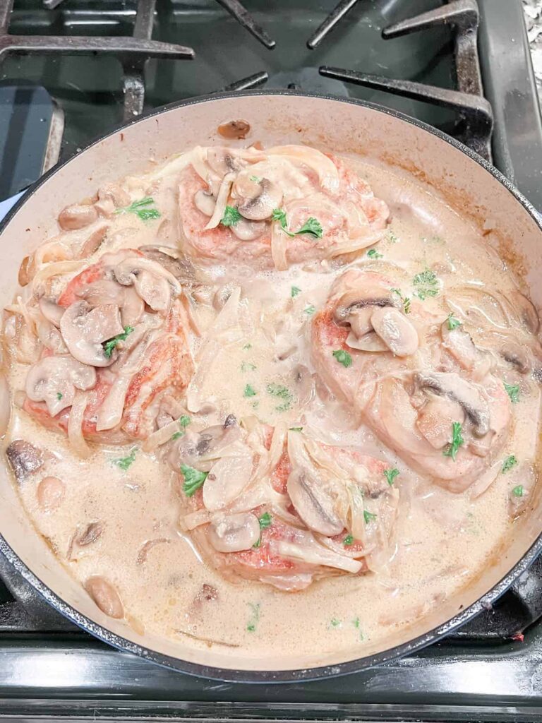 Mushroom cream sauce pork chops in pan