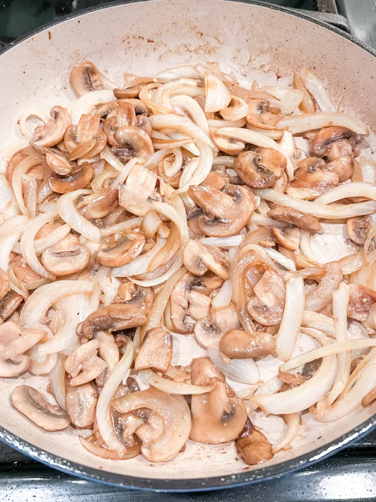 Mushrooms and onions in pan