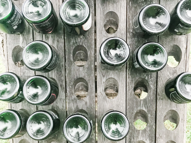 Wine bottles on a riddling rack