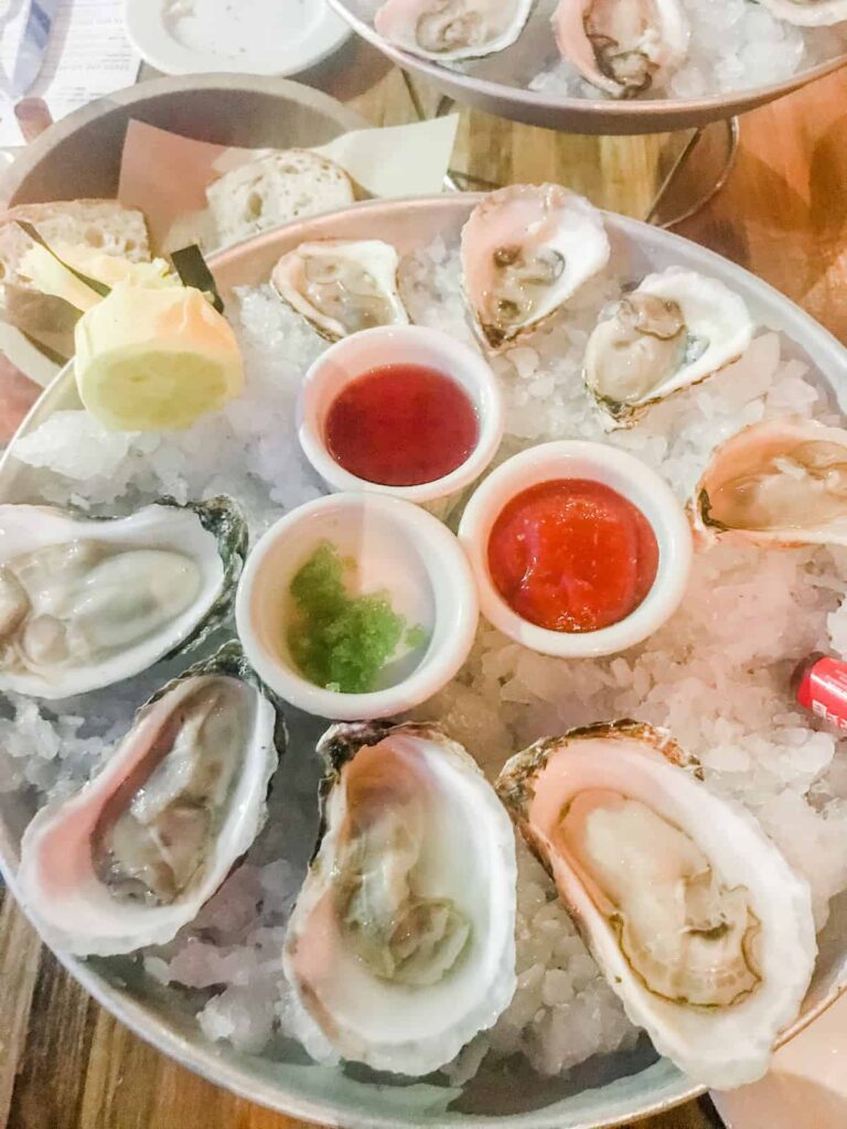 Oysters on a bed of ice with cocktail sauce