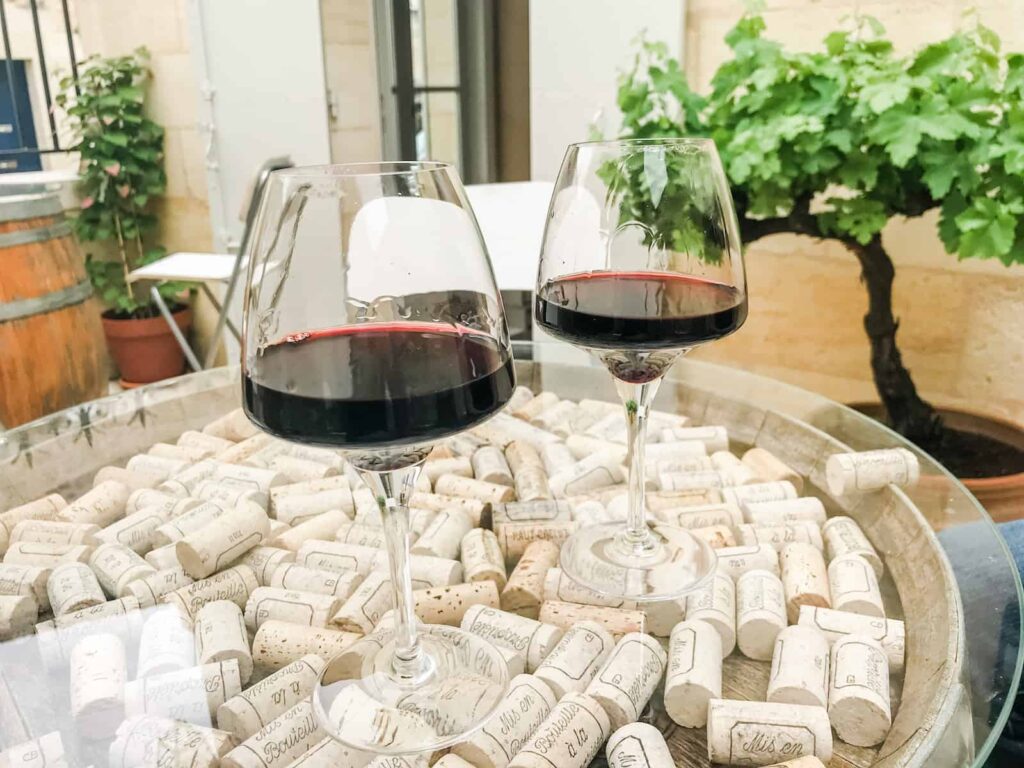 Two glasses of red wine on an outdoor table