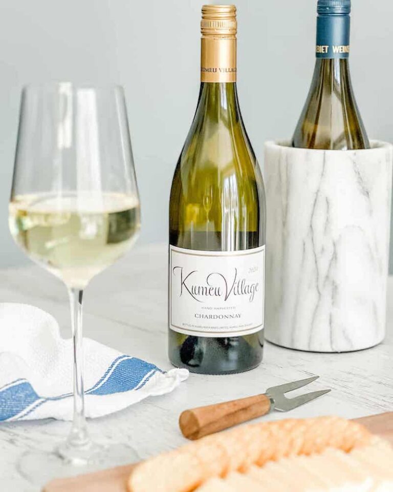 Bottle of dry Chardonnay and glass of white wine
