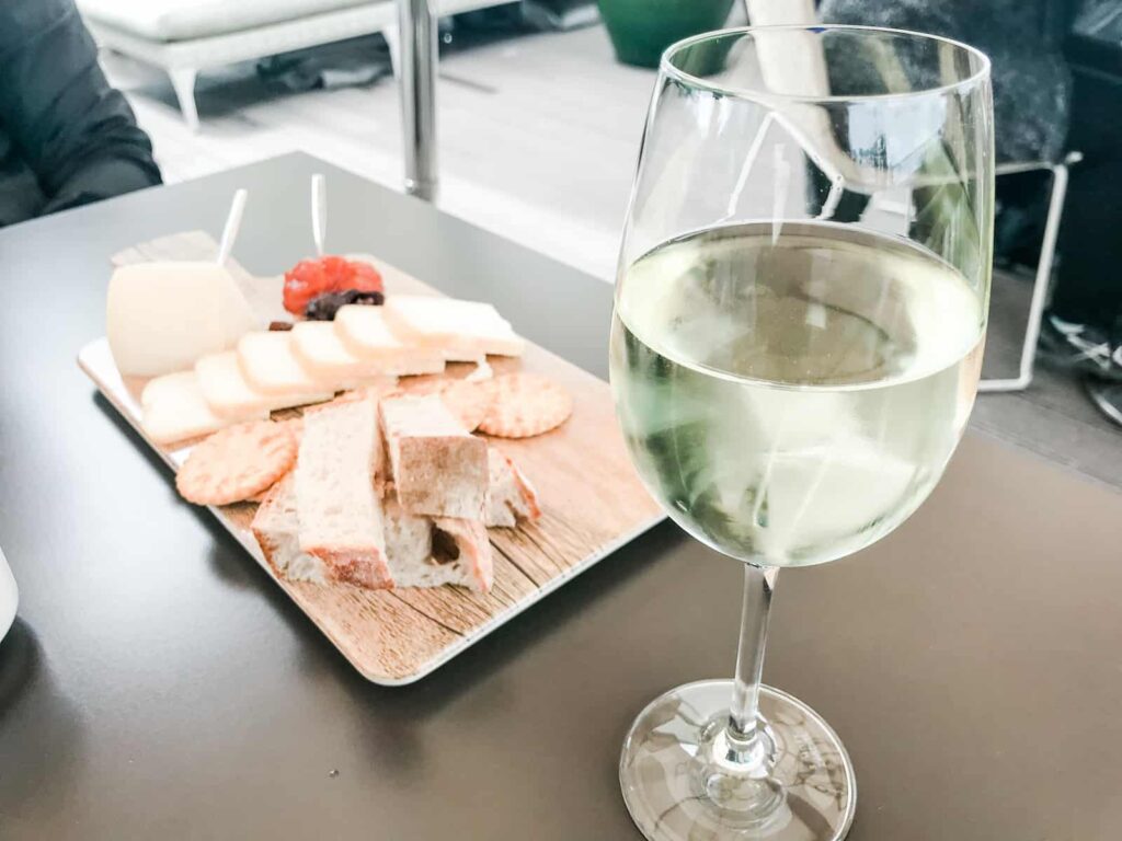 Espaco Porto Cruz cheese plate and glass of white wine
