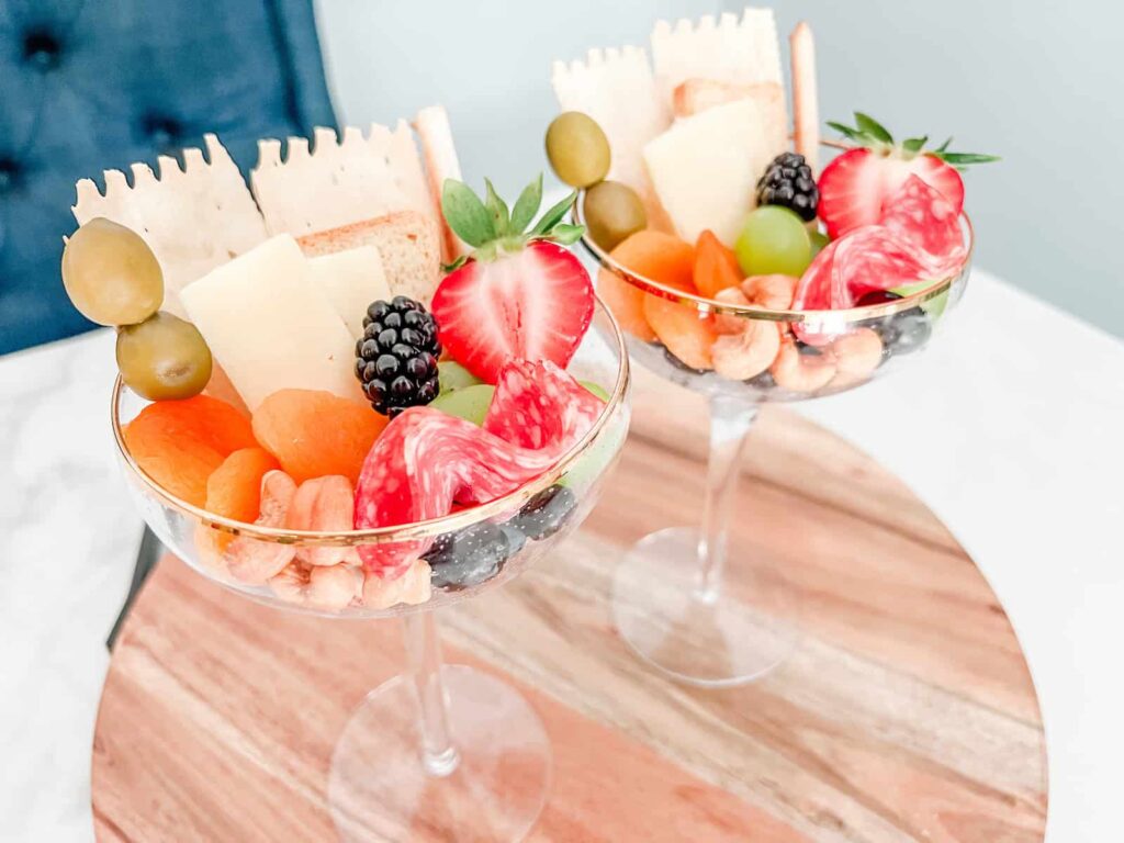 Charcuterie glasses on a wooden board