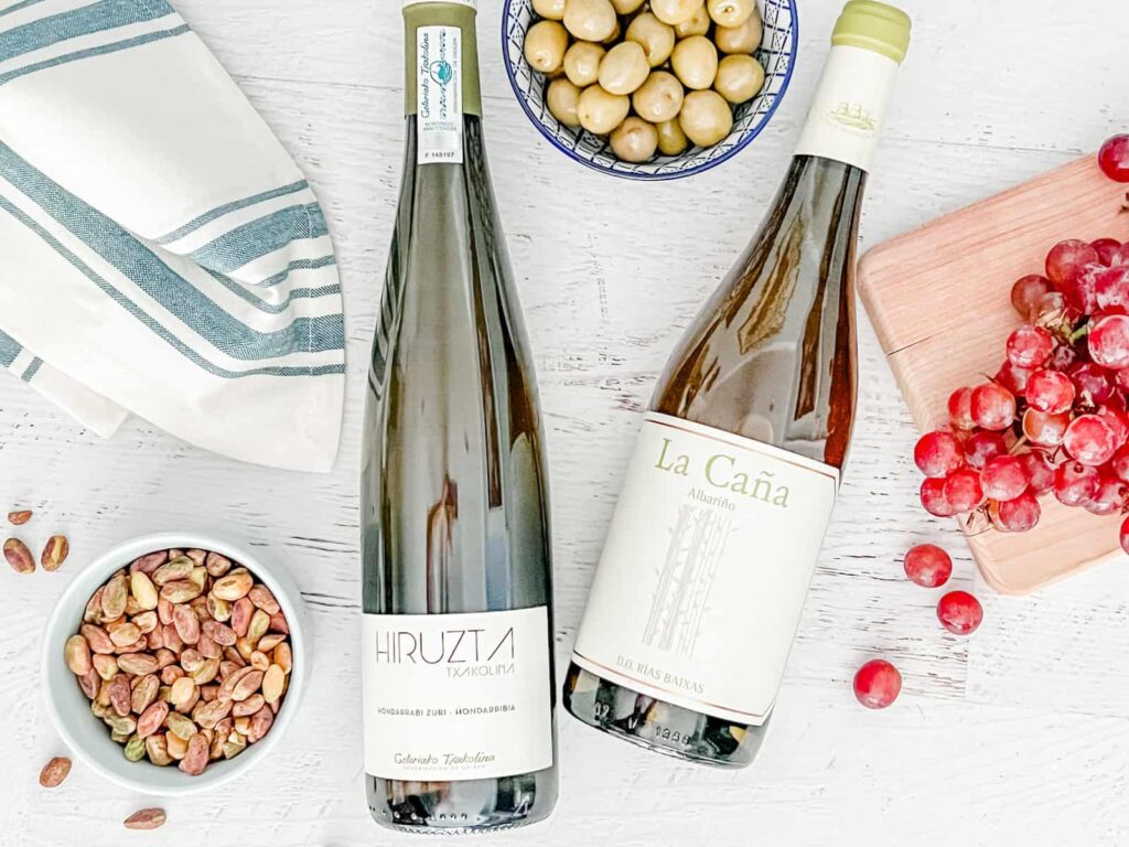 Spanish white wines with grapes, olives, and nuts