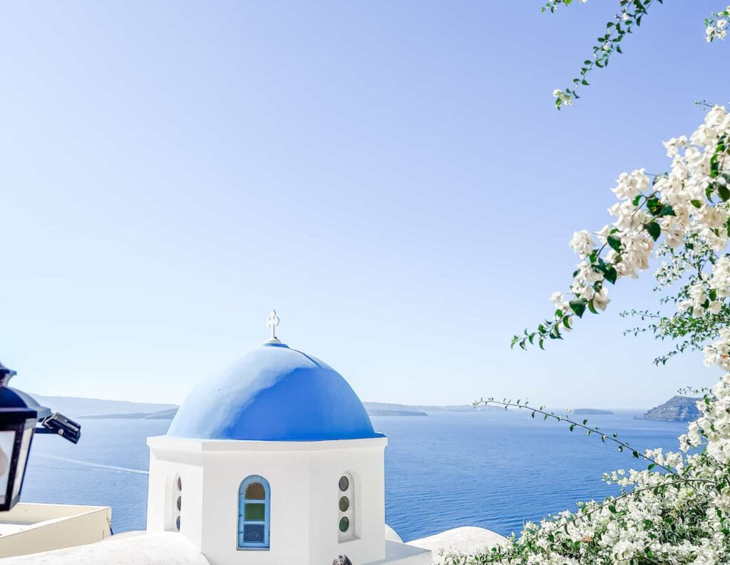Blue domed church with ocean in background