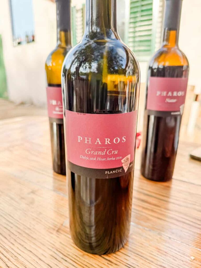 Close-up of a bottle of Pharos Grand Cru red wine from Braća Plančić, labeled with its origin in Dubje, Hvar.