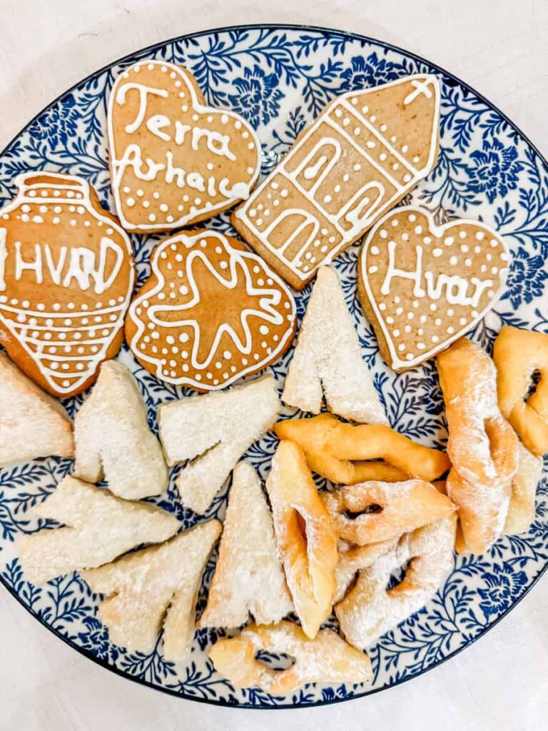 Traditional Hvar cookies and pastries, including iced shapes like hearts, stars, and buildings with “Hvar” and “Terra Achaica” written in icing.
