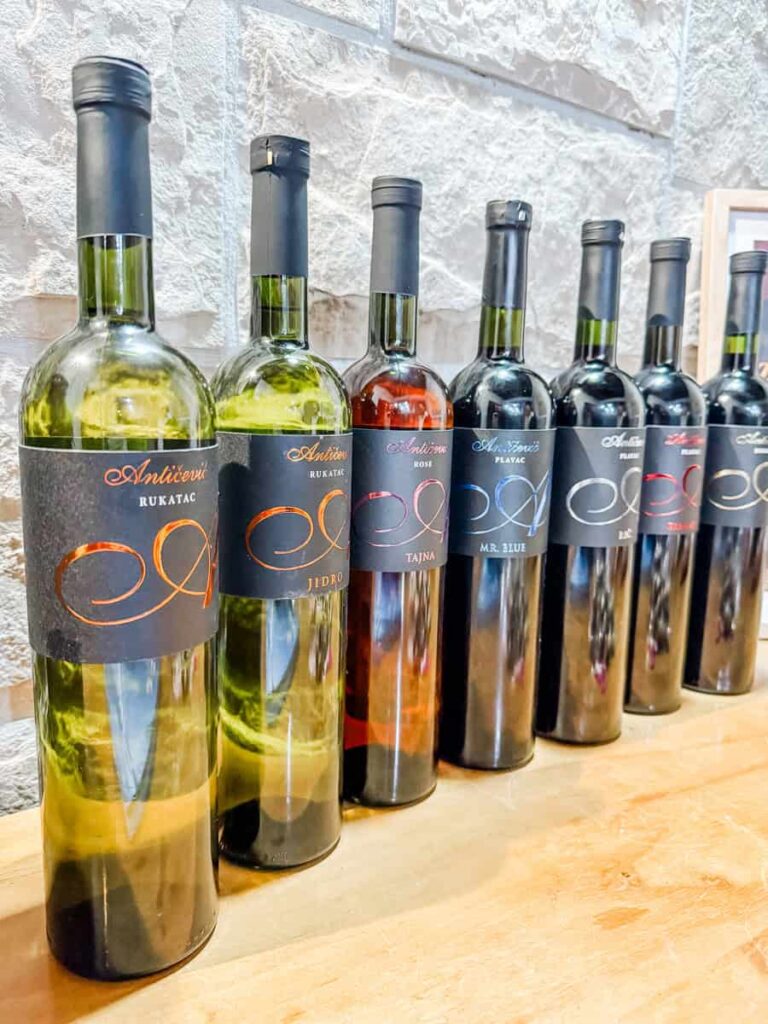 Selection of Antičević wines, including Rukatac, Plavac, and rosé, displayed in the tasting room.