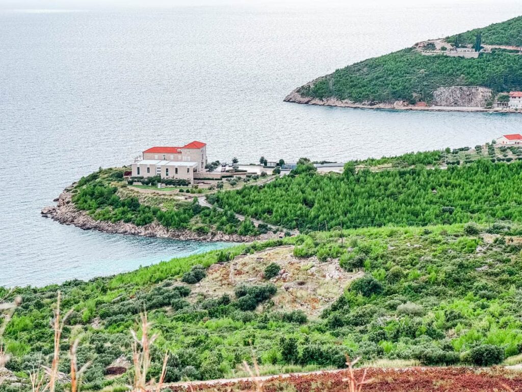 Grgić Vina winery building surrounded by vineyards on a small peninsula along the Adriatic coast.