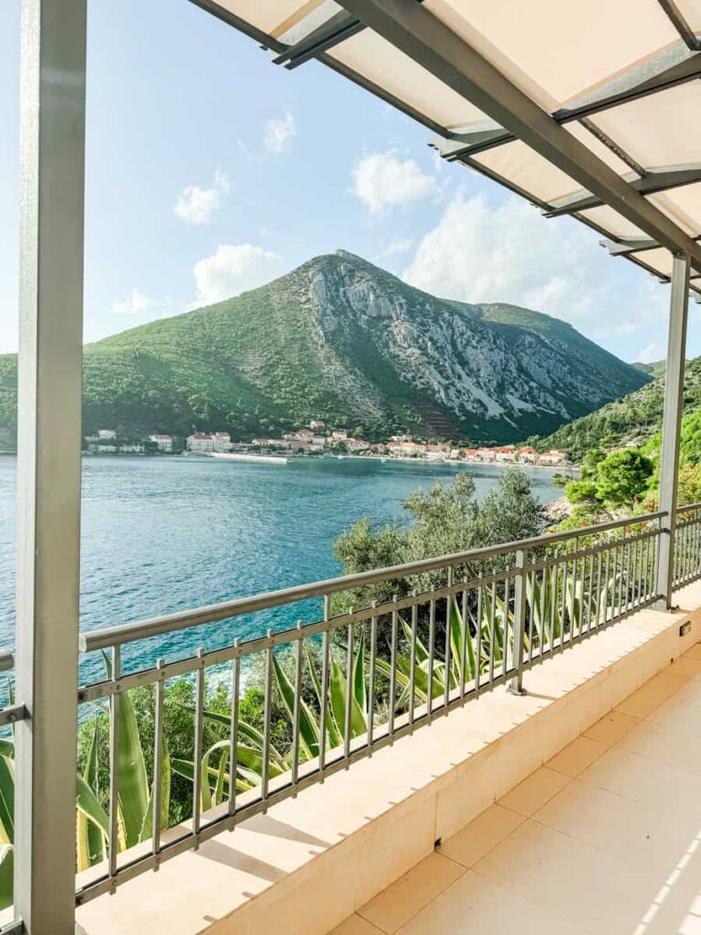 Balcony view from Grgić Vina with Adriatic Sea and mountain backdrop.