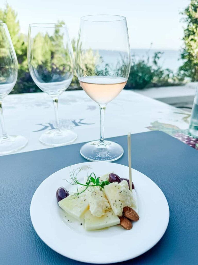 Wine tasting at Korta Katarina with rosé wine and cheese plate overlooking the sea.