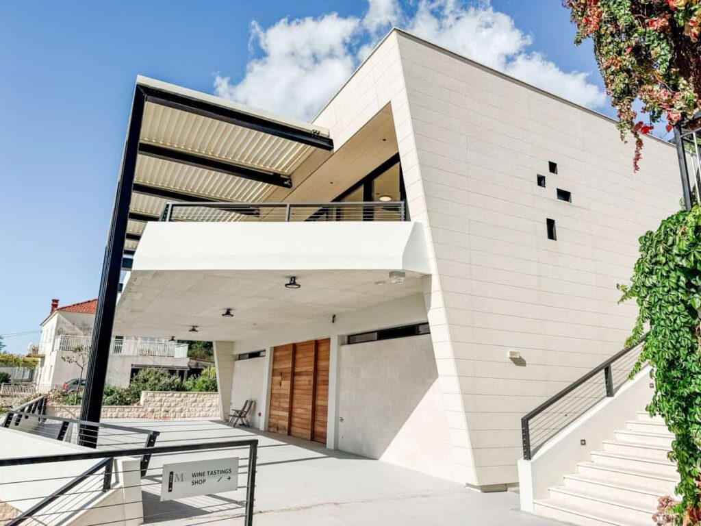 Modern exterior of Miloš Winery on the Pelješac Peninsula with wine tasting shop entrance.